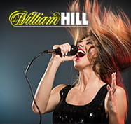 Una ragazza durante un concerto e il logo di William Hill